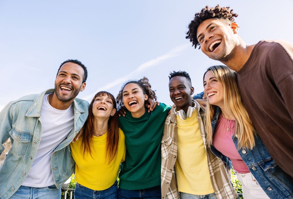 a mulitcultural group of happy smiling young people posing to a photo