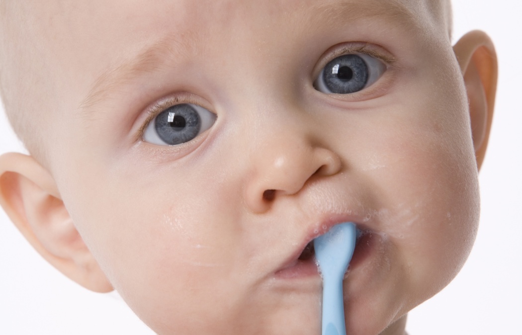 Baby boy is pretending to brush his teeth